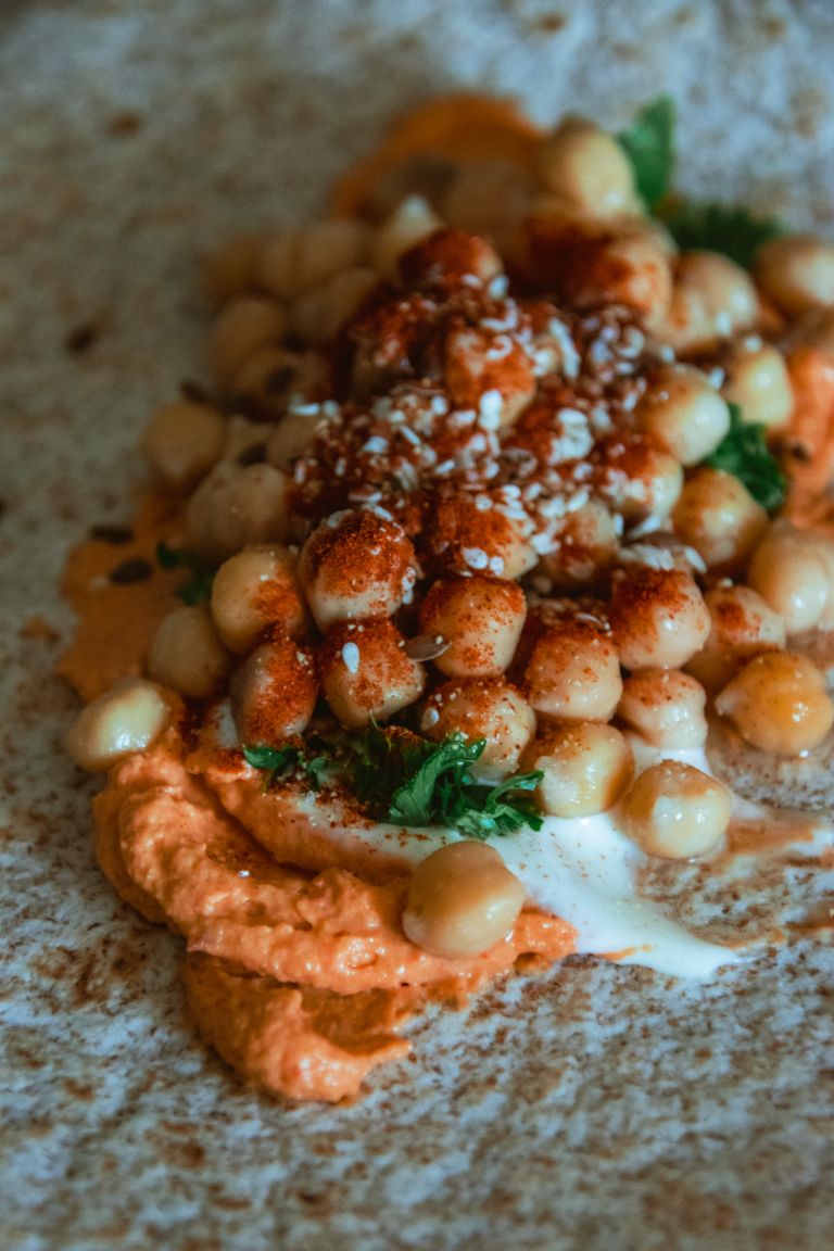 Delicious chickpea wrap featuring creamy sauces and fresh herbs, perfect for a flavorful meal.